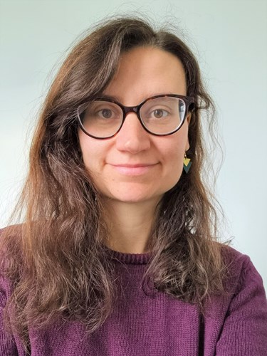 Image of woman with brown hair and glasses